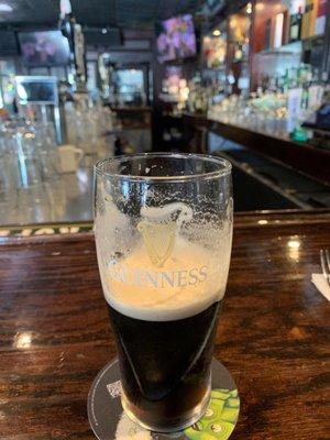 A Guinness at the end of the bar.