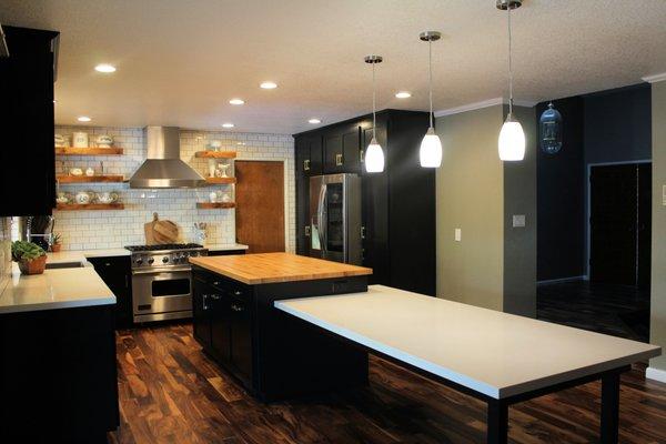 Hamden Kitchen After - Shaker black cabinets, Oak butcher block island with attached unique dining table with quartz top.