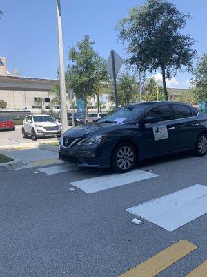 Roy's delivery parked in front of crosswalk preventing individuals with wheelchairs, walkers and strollers to access hospital.