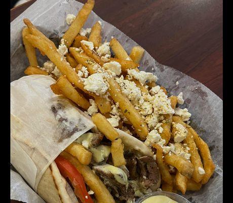 Gyro with fries top with feta and oregano