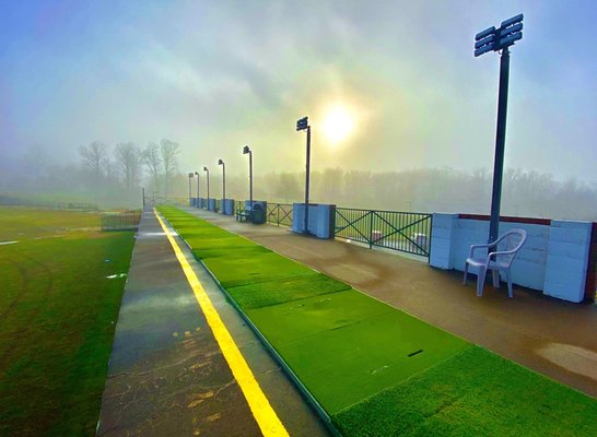 Sunrise wiping away the morning fog on the upper deck range at VGC.