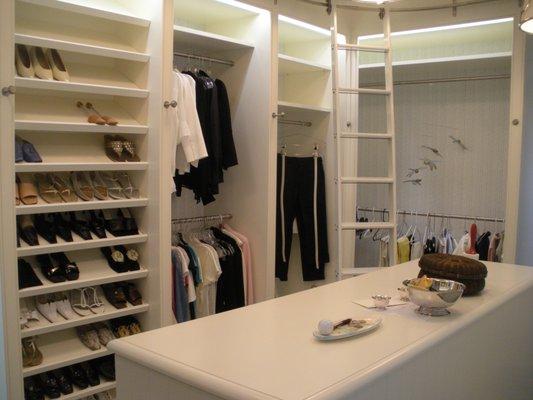 An example of our work in a private residence. A walk in closet with space for shoe racks, clothes hanging space, island and rolling ladder.