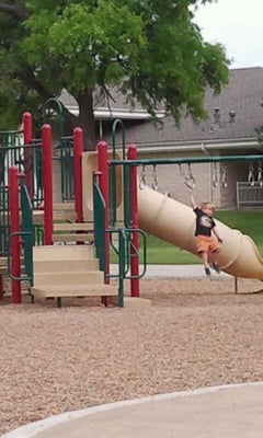 Kaden tackles the monkey bars