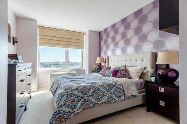 Embracing the purple graphic wallpaper, textiles and decorative pillows in deep blues and lavenders were selected.