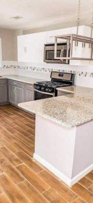 Remodeled kitchen with marble countertops .