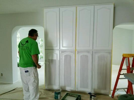 Changing kitchen cabinets to a new brighter finish.