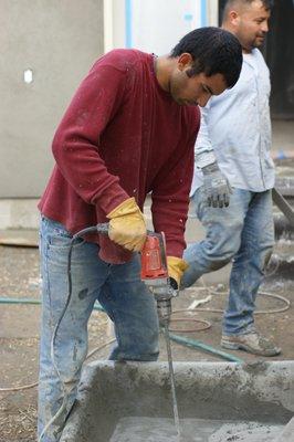 Luis, mixing cement.