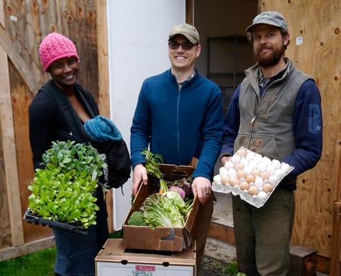 Victoria, Chris and Matthew show off fresh produce and eggs for the Seattle Tilth CSA.