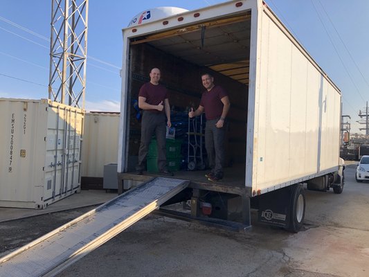 Our Friendly Movers in Plano are unloading a customer's stuff into a storage unit.