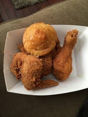 3 piece fried chicken (leg, wing and thigh) with a biscuit.