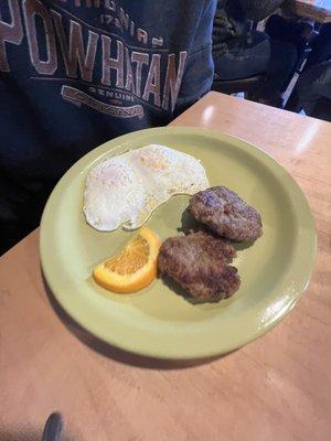 This is the Saint Ames breakfast which included eggs, sausage and oranges.