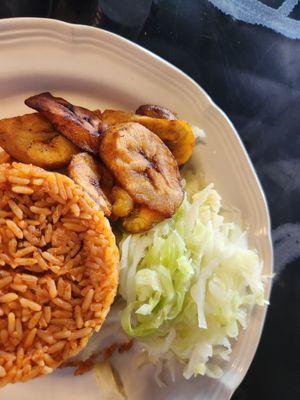 Jollof rice, fried plantains and cabbage