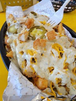 $7.50 meal of Bee Sting (spicy) loaded fries with chopped chicken tenders inside.