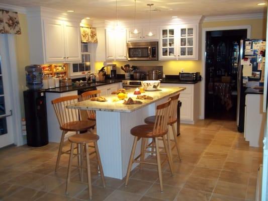 Brightened up this kitchen with stunning white cabinetry, beadboard around the island, granite and 100 ft of crown moulding