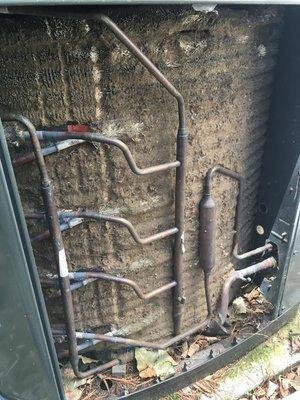 Condenser coil on outside air coditioning unit before maintenance cleaning.