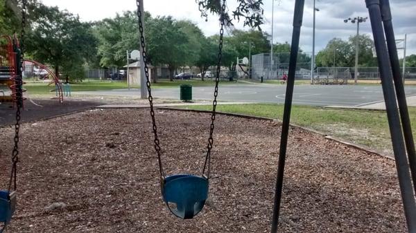 Ine of several swings. Basketball court in background