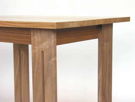 High dining table with bookmatched elm slab top and walnut legs