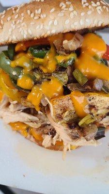 Shredded Chicken, grilled onions and bells with green chile or jalapenos and cheese. Great with shredded beef also! On a toasted bun.