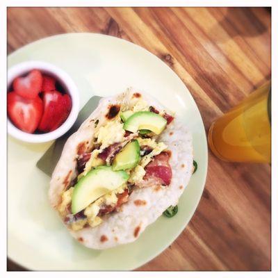 Breakfast taco with fresh homemade tortilla, scrambled eggs w/ pepper jack cheese, diced bacon and avocado, plus serrano chiles on the side.