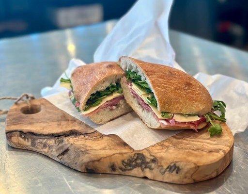 Piadini: A southern Italy classic! Fresh prosciutto layered with shaved parmesan and arugula. We add just a touch of extra virgin olive oil.