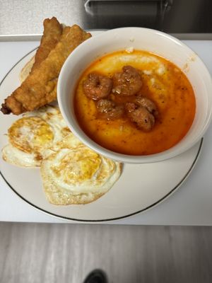 Fried fish and grits with fried eggs