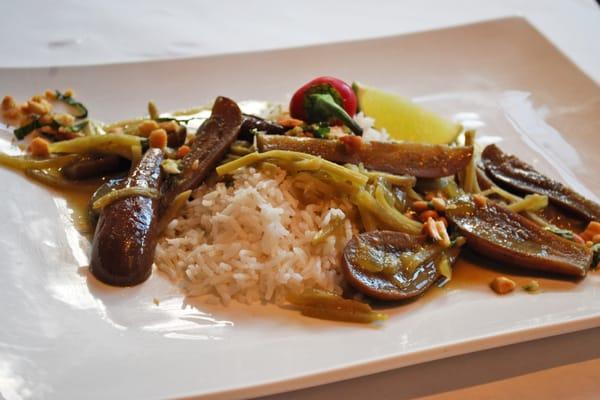 Local eggplant with green curry, coconut rice and thai peanut gremolata at cafe nola