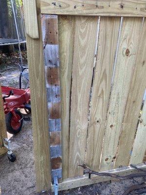 Used and weather worn wood on a new fence