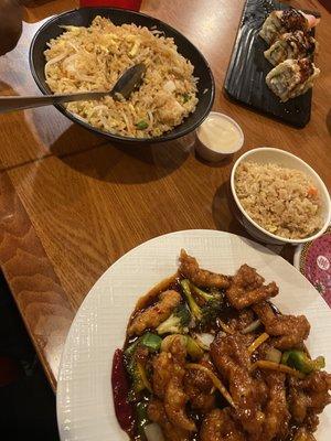 Fried rice, Orange chicken, and Eel roll (?)