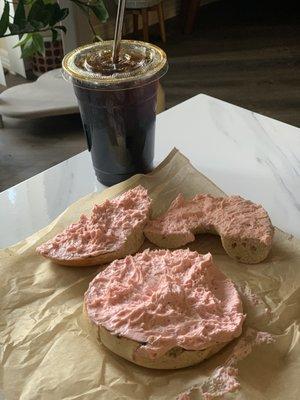 Honey wheat bagel with Extra strawberry cream cheese and a cold brew coffee