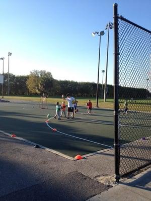 Coaching kids on basic basketball dribbling.