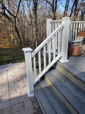 Vinyl railing and post installed on each side of the stairs.