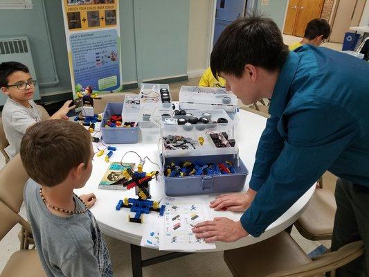 Instructors providing guidance on how to construct an electric fan.