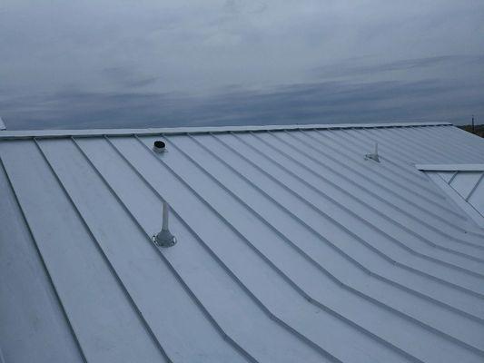 Standing seam roof installation.