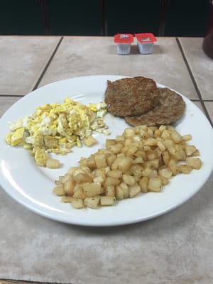 Scrambled eggs with home fries and sausage.