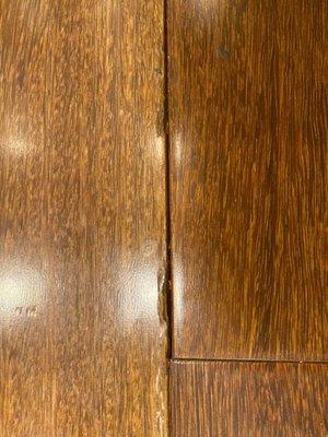 They put in brand new Brazilian Chestnut hardwood. As you can see they managed to horribly dent it and misalign it.