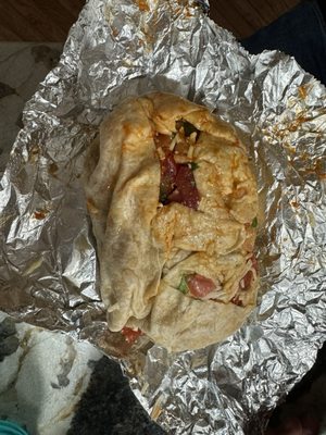 Burrito that became a mess on the foil and the floor after the first bite