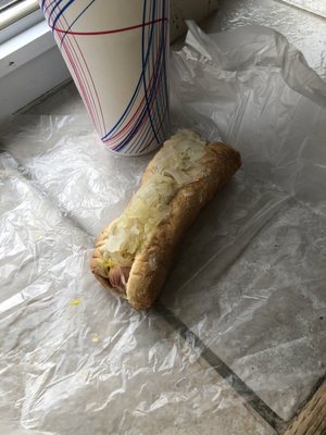 Hot dog with sauerkraut and mustard and drink