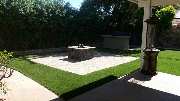 Artificial turf and a fire pit with pavers