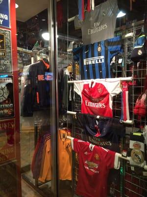 Several European football club jerseys on display in the front window. None in store.