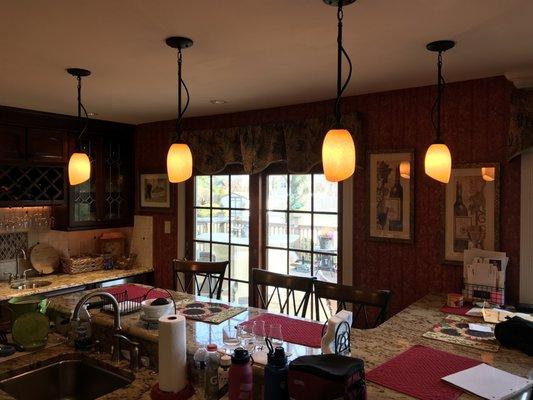 Pendant fixtures installed over kitchen counter.