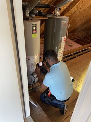 We inspect water heaters and other equipment in the attic to check for potential issues.