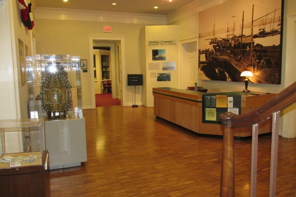 foyer area inside the Lyceum, showing reception desk, two lighthouse lamps at side