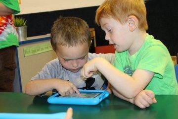 Preschoolers in our Child Development Center use technology as well as traditional methods to learn.