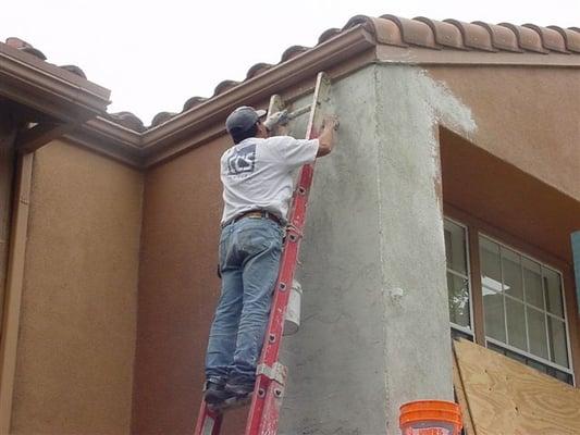 exterior plaster repair in progress after extensive dry rot damage/repair.