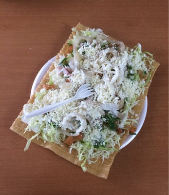 CUERITOS -a 5x7 chicharron chip with shredded cabbage, lime juice, cilantro, tomatoes, cheese, and pickled pork skins. SO YUM!