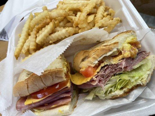 Ham sub sandwich with fries.