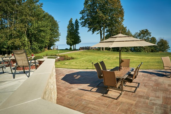 Residential landscape design and build including paver brick patios, landscaping, and lighting.