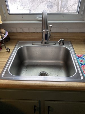 Newly installed sink/ faucet with leaking pipes under sink repaired