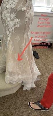 See-through from the hip downward and paper in the base of the gown to prove that it is unfinished and carelessly done...