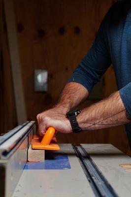 Woodworker in woodshop using tools